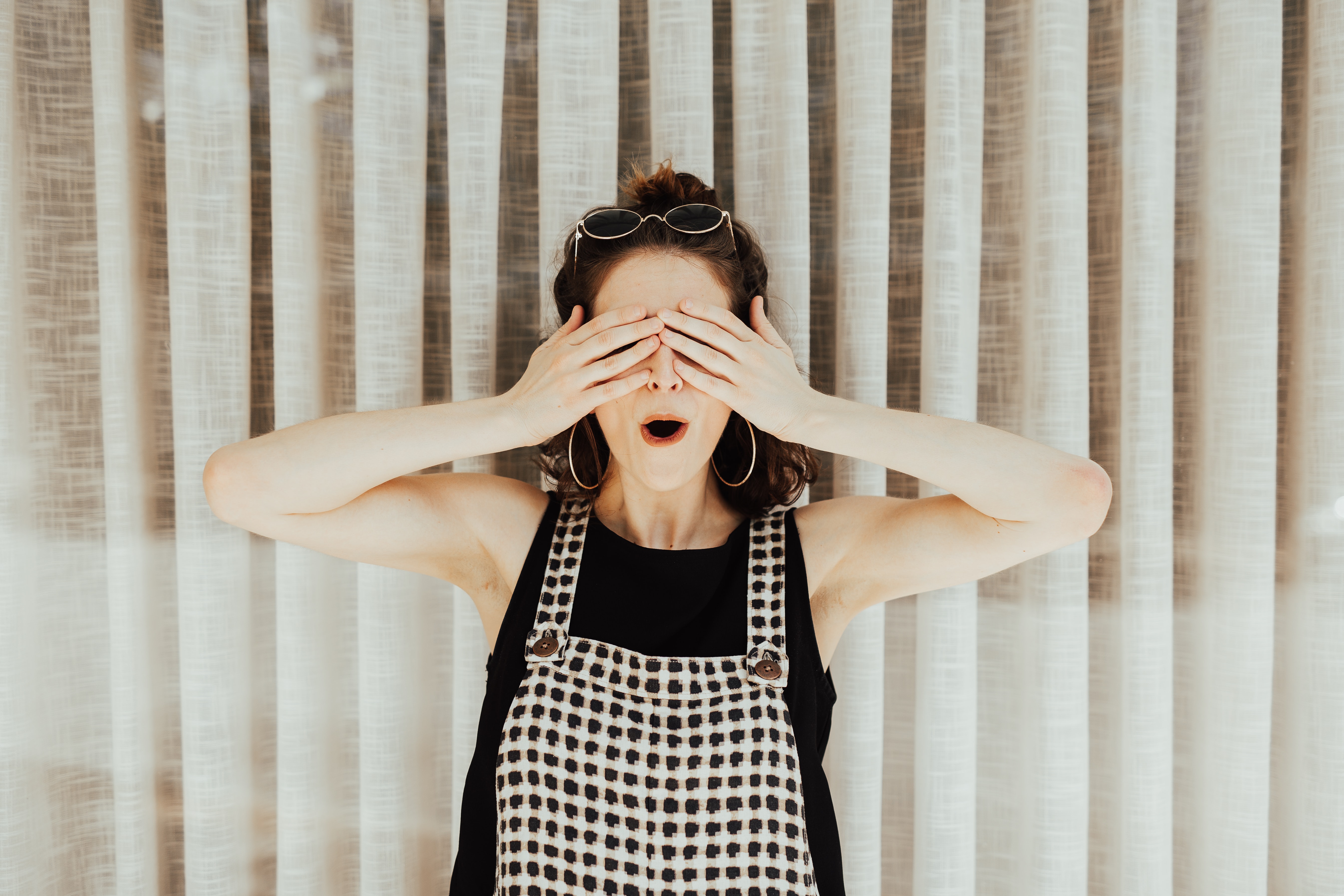 woman hiding her eyes with hands