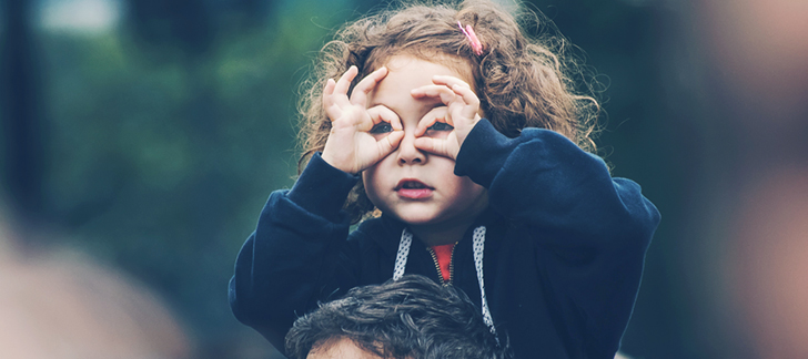 Child making glasses with her fingers